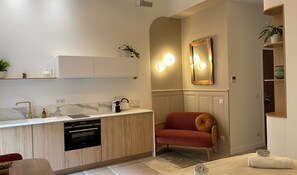 Enjoy meals in the kitchen with a dishwasher and oven, and relax in the adjacent seating area with a sofa and side table.