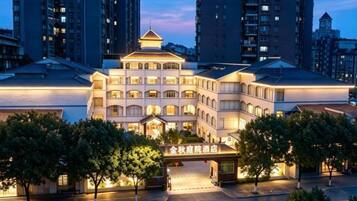 A multi-story hotel with a central atrium, multiple balconies, and a prominent entrance.