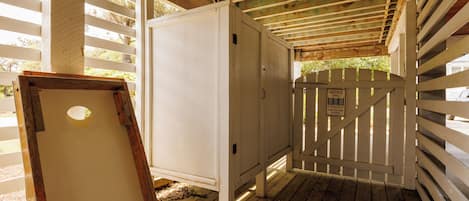 A wooden structure with a white door and a notice sign.