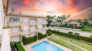 A residential building with a swimming pool, balconies, and a view of the neighborhood. - Yourhouse El Xiprer (Pollensa)