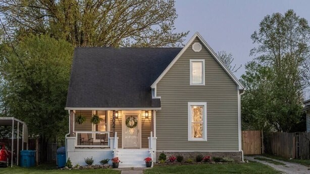 A single-story house with a dark roof, a front porch with steps, and a small front yard with a pathway leading to the entrance. - “Bourbon Trail Beauty” (Lawrenceburg)
