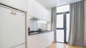 A modern kitchen with white cabinets, a black countertop, and a built-in stove. - VLC HOST - San Jacinto A (Valencia)