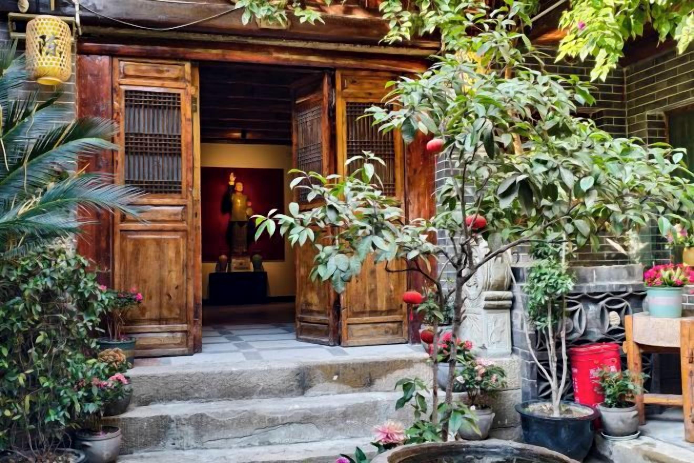 A traditional wooden building with a stone staircase leading to a door.
