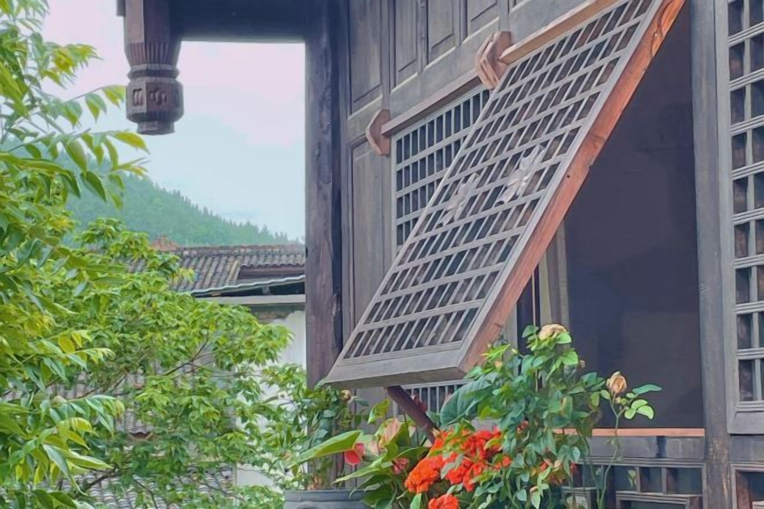 A traditional building with a slanted roof and a window with a grid pattern.