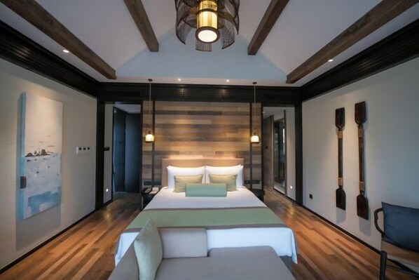 A modern bedroom with a large bed, wooden flooring, and a unique wall design. - Wuxi Nianhua Bay Polomydo Hotel, (Wuxi)