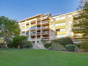 Stunning residential building with balconies and lush surroundings.