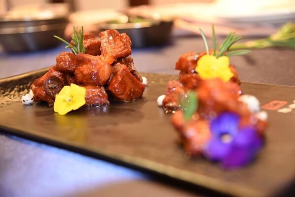 A plated dish with food garnished with flowers. - Dahe International Hotel (Zhengzhou East Railway Station) (Zhengzhou)
