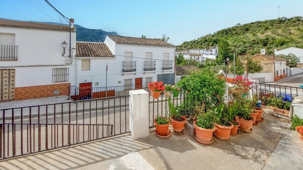 A residential area with white buildings, terracotta roofs, and a hillside. - 2 bedroom gorgeous home in Algodonales (Algodonales)