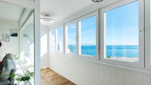 A bright, sunlit hallway with large windows overlooking a beach. - Magic of the ocean, Front Line Beach Apartment (TORREMOLINOS)