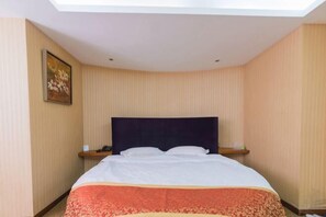 A hotel room with a large bed, a headboard, a nightstand, and a painting on the wall. - Home Inns in Liushi Yueqing (Yueqing)