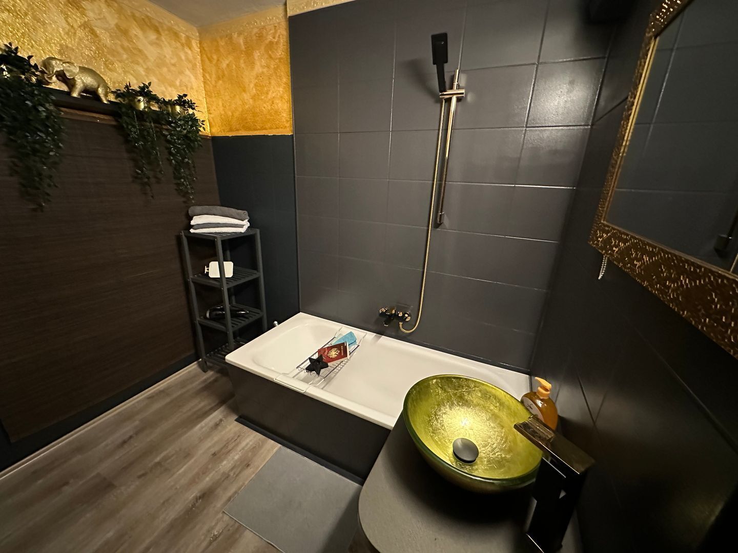 A modern bathroom with a bathtub, a shower, and a sink.