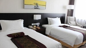 A hotel room with two beds, a nightstand with a phone, a lamp, and a chair. - Tianzhu Mountain Wangfu International Hotel (Qianshan)