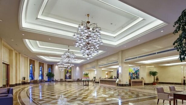 A spacious lobby with a checkered marble floor, large chandeliers, and a reception desk. - Tianzhu Mountain Wangfu International Hotel (Qianshan)