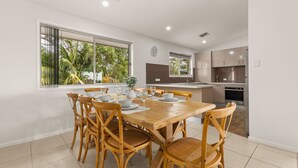 A modern kitchen with a dining area.