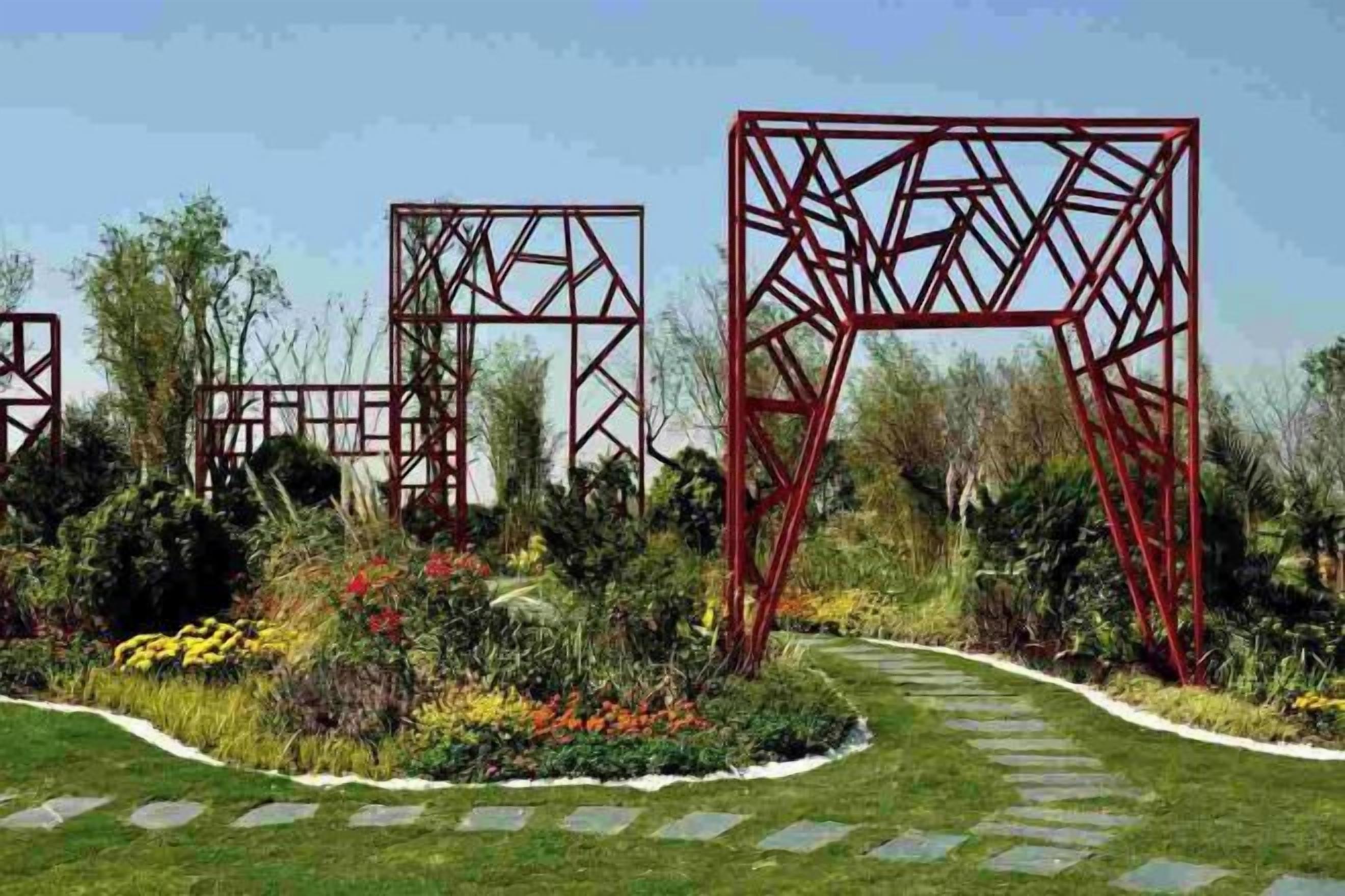A garden with red metal structures and a stone pathway.