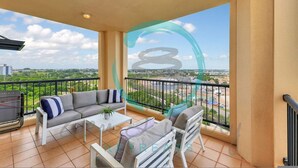 A balcony with a sofa, chairs, and a table. - Zen Gem Pool Private Balcony Oceanview (Darwin)