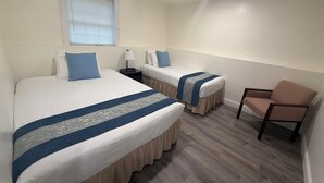 A hotel room with two beds, a chair, a window, and a nightstand. - Cozy, comfy,quiet &close to casinos (Montville)