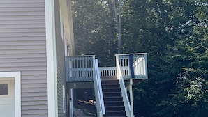 A two-story building with a covered outdoor staircase leading to a deck. - Cozy, comfy,quiet &close to casinos (Montville)