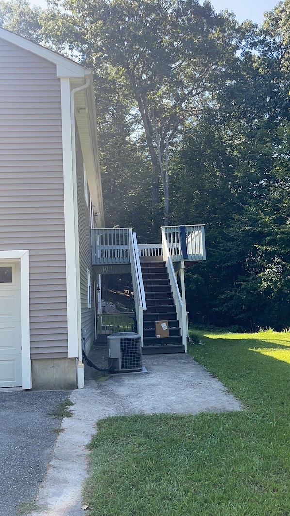 Un bâtiment à deux étages doté d’un escalier extérieur couvert qui mène à une terrasse.