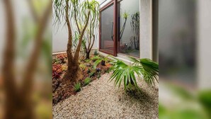 A modern building with a glass door and a gravel pathway. - Akeiro Machiya House (Kyoto)