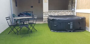 Enjoy an outdoor space with a table and chairs, perfect for relaxation.
