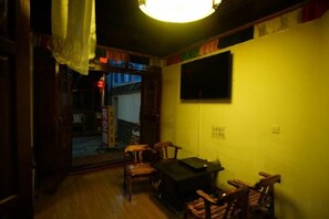 A room with a wooden floor, a black table, and several chairs. - Fengyuan Inn (Guangzhou Renjia) (Shangri-La)