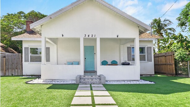 A single-story house with a front porch, a mailbox, and a number '3421' on the front wall. - 4BR Charming Home By Beachside (West Palm Beach)