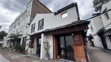 A traditional building with a storefront, large windows, and a visible entrance.