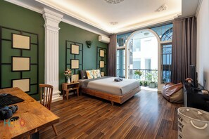 A modern bedroom with a wooden bed, a desk, and a balcony with a view. - New HoLo Le Thanh Ton SaiGon (Ho Chi Minh City)