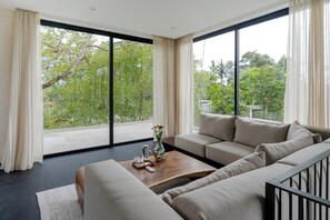 Villa, 1 très grand lit | Coin séjour