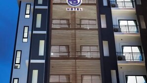 A hotel building with a prominent logo and the word "HOTEL" displayed on the facade. - B Hotel Khon Kaen (Khon Kaen)
