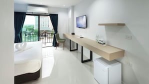 A hotel room with a bed, a desk with a computer, a TV, and a small fridge. - B Hotel Khon Kaen (Khon Kaen)