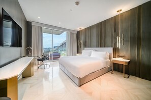 Enjoy a city view from the large window, with a comfortable seating area and a spacious bed.