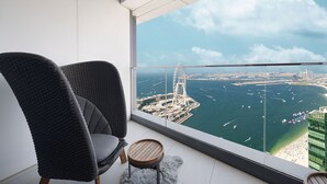 A balcony with a view of a coastal cityscape, including a prominent bridge and marina.