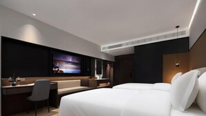A modern hotel room with a large bed, a desk, a television, and a seating area. - mutai Hotel Changsha (Changsha)