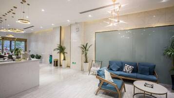 A modern reception area with a reception desk, seating area, and a large window.