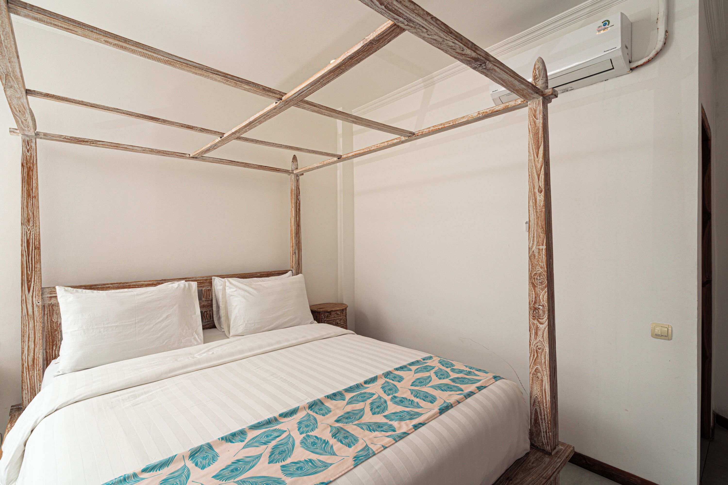 A room with a four-poster bed, white bedding, and a wooden ceiling structure.