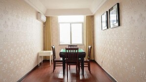 A room with a billiards table, a small white table, and a window with curtains. - Zixing Dada Business Hotel (Zixing)