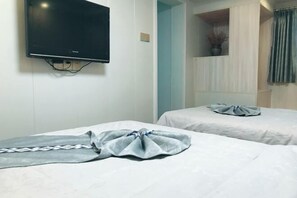A hotel room with two beds, a flat-screen TV mounted on the wall, and a window with curtains. - Painting Base in Yun Shui Trackway (Nanjing County)