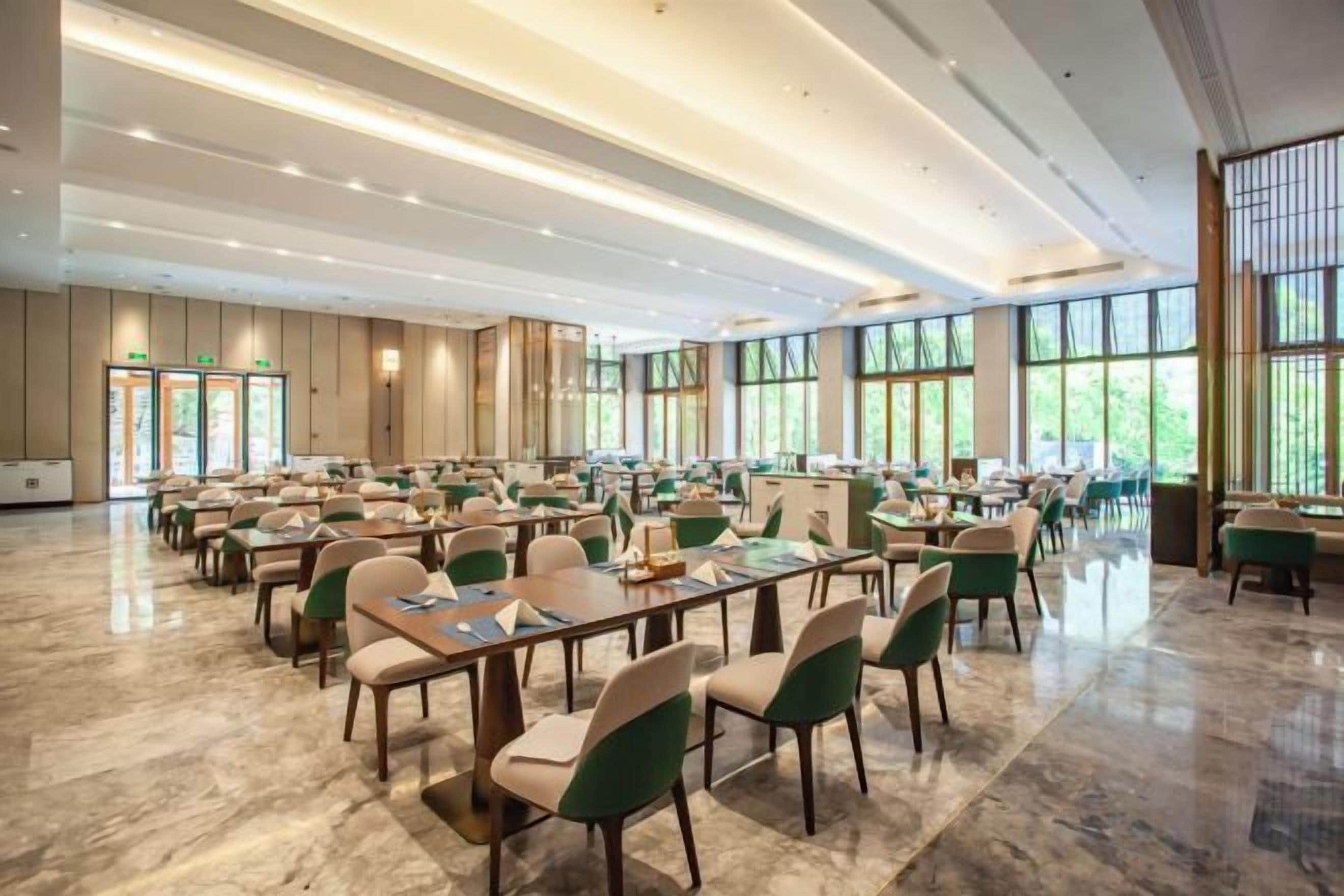 A spacious conference room with tables and chairs arranged for meetings.