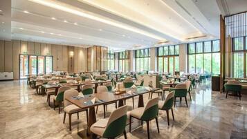 A spacious conference room with tables and chairs arranged for meetings.