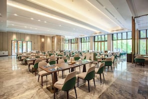A spacious conference room with tables and chairs arranged for meetings. - Shenxianju Narada Resort (Xianju)