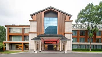 A modern building with a central entrance, large windows, and a flat roof.