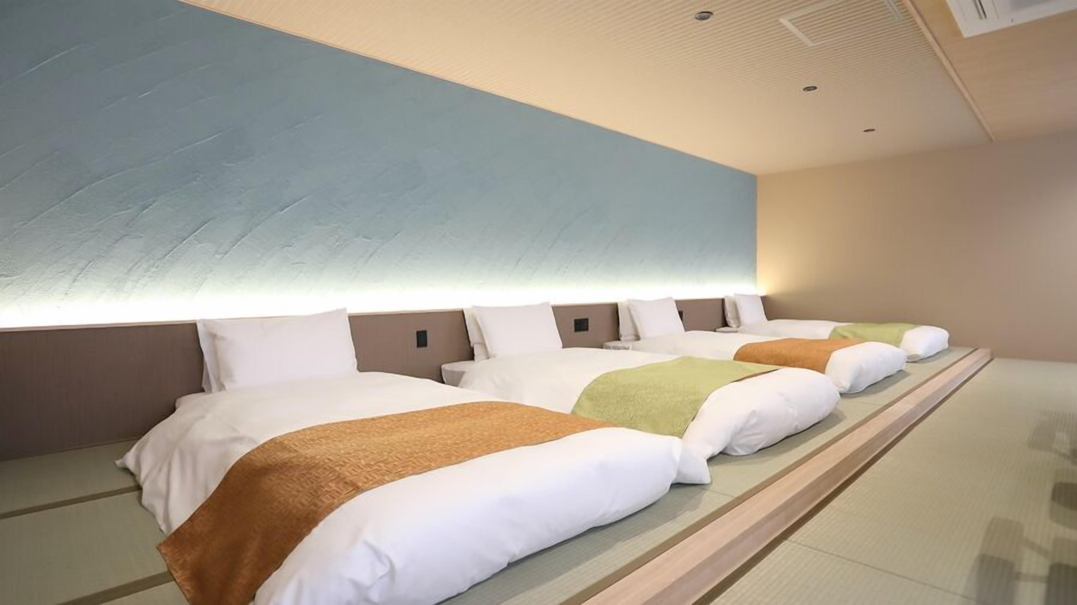 A hotel room with three beds, a large wall mural, and a modern ceiling design.
