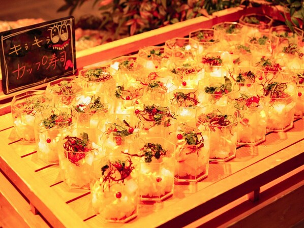 A display of clear glass containers with decorative elements, possibly for a special event or promotion.