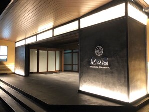 A building entrance with a sign reading 'MIYAWA KAI TORANO-YU' and a wooden ceiling.