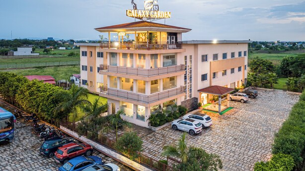 A multi-story hotel with a prominent sign reading 'Galaxy Garden.' - Galaxy Garden Resort (Bharatpur)