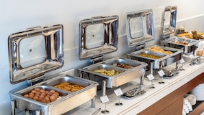 A buffet line with various food items and utensils. - Galaxy Garden Resort (Bharatpur)