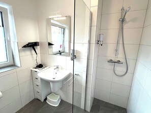 Shower, hair dryer, towels, soap