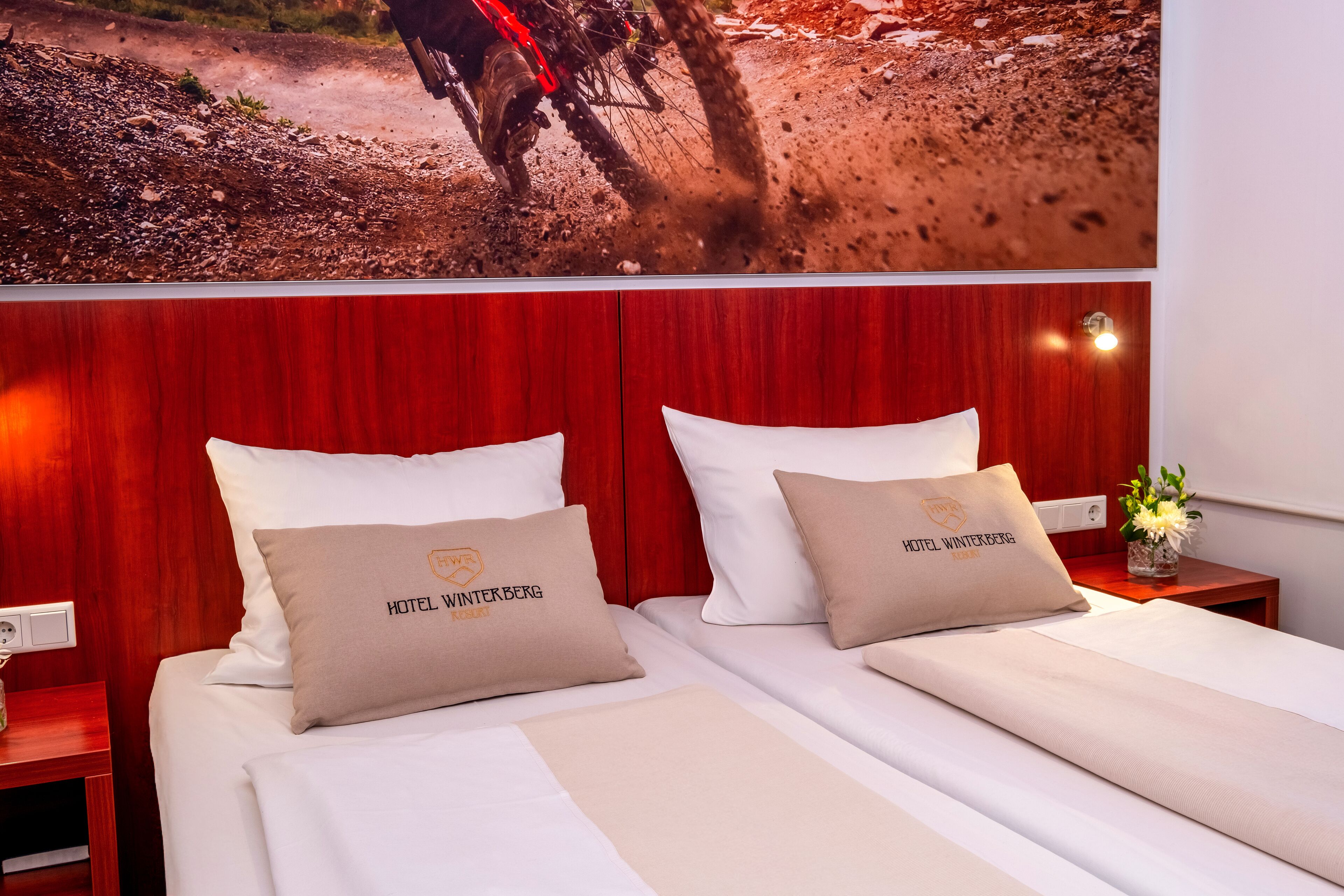 A hotel room with two beds, each with a pillow labeled "HOTEL WINTEKBERG."